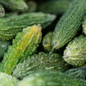 A detailed close-up shot of fresh green bitter gourds, showcasing their texture.